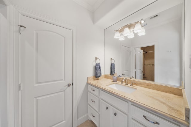 bathroom featuring crown molding, vanity, and walk in shower