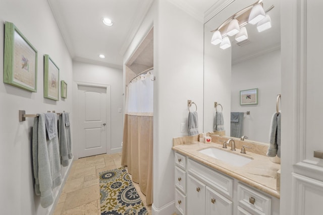 bathroom with vanity, curtained shower, and ornamental molding