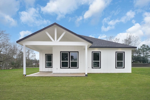 rear view of property with a lawn