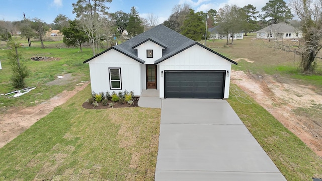 modern farmhouse style home with a front lawn and a garage