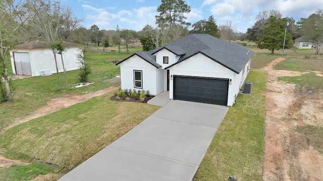 modern farmhouse featuring a front yard, central AC, and a garage