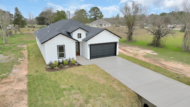 modern farmhouse style home featuring a front yard and a garage