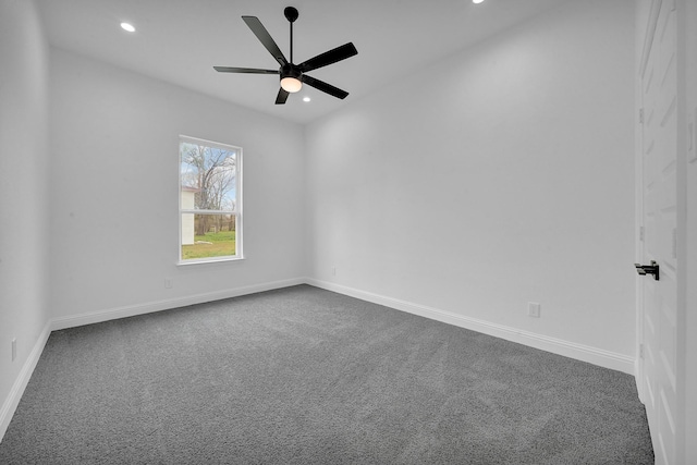 carpeted spare room featuring ceiling fan