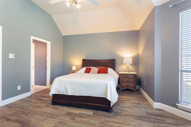 bedroom featuring ceiling fan, hardwood / wood-style floors, and vaulted ceiling