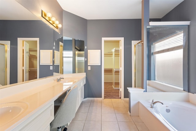 bathroom with tile patterned flooring, vanity, and a tub to relax in