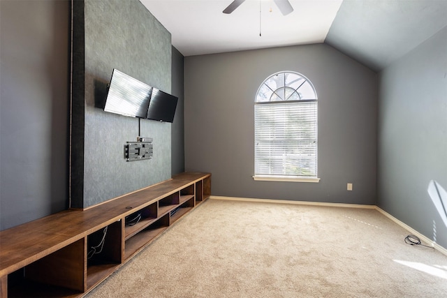 interior space with carpet flooring, ceiling fan, and vaulted ceiling