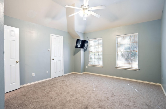 unfurnished room featuring carpet flooring, ceiling fan, and vaulted ceiling