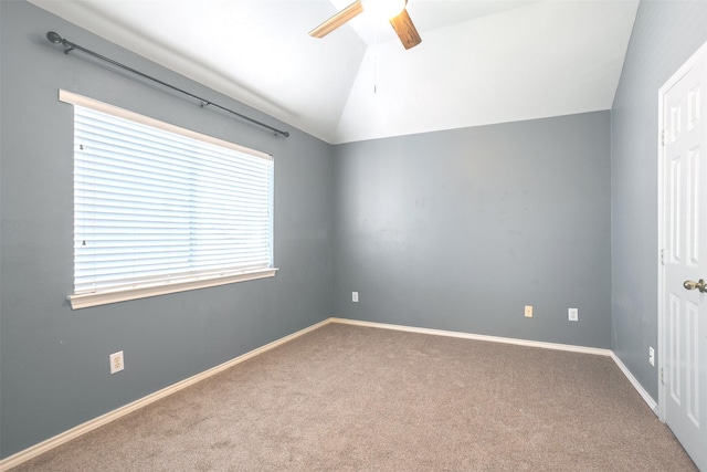 carpeted empty room featuring vaulted ceiling and ceiling fan