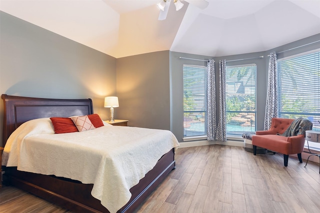 bedroom featuring a raised ceiling, ceiling fan, and hardwood / wood-style floors