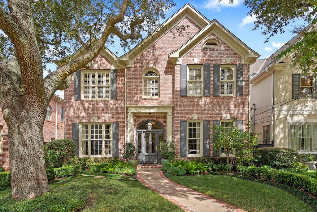 view of front facade featuring a front yard and french doors