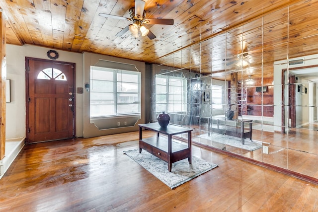 foyer featuring a healthy amount of sunlight, ceiling fan, wooden ceiling, and hardwood / wood-style floors