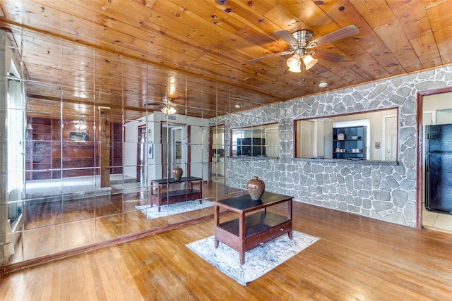 living room featuring hardwood / wood-style floors and wooden ceiling