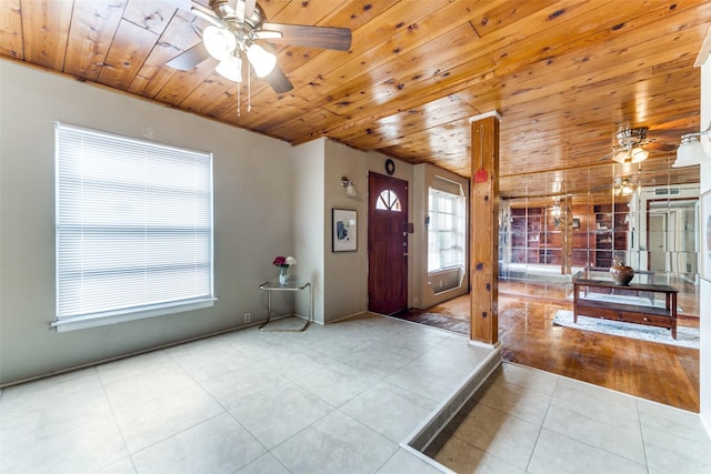 entrance foyer with a wealth of natural light, tile patterned flooring, and wood ceiling