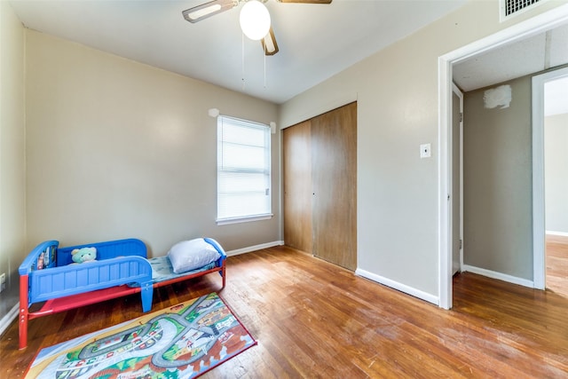 living area featuring ceiling fan and wood-type flooring