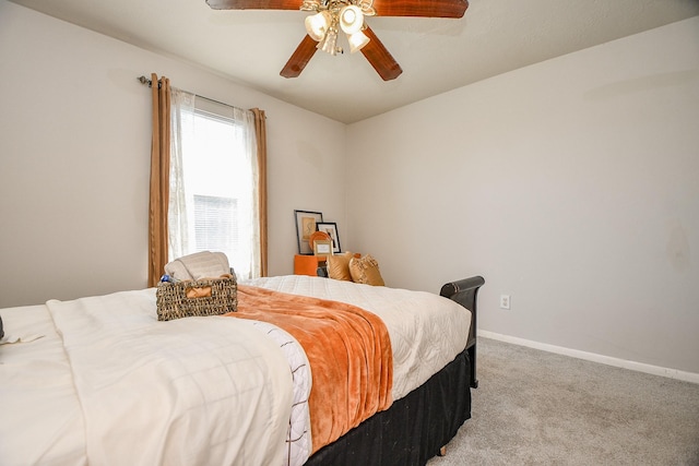 bedroom featuring light carpet, ceiling fan, and baseboards