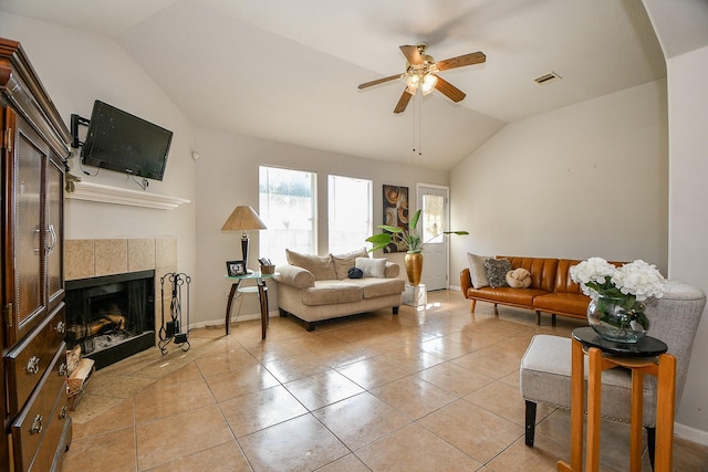 living room with vaulted ceiling, light tile patterned floors, a fireplace, and visible vents