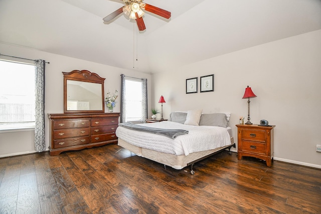 bedroom with lofted ceiling, dark wood finished floors, baseboards, and ceiling fan