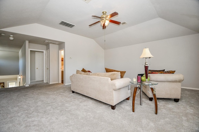 living area with lofted ceiling, visible vents, and light carpet