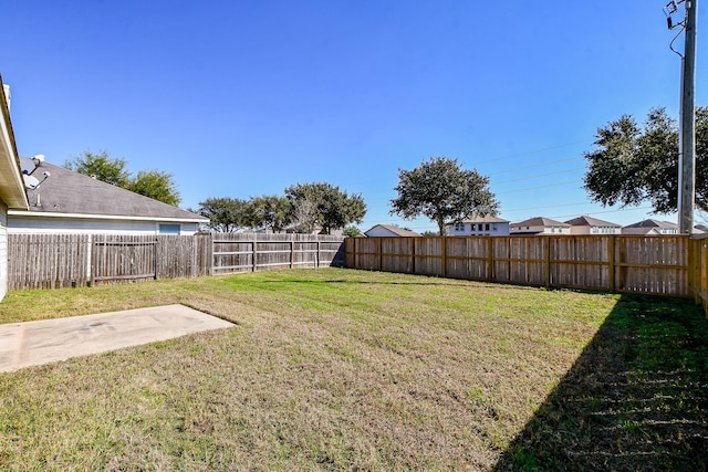 view of yard with a fenced backyard