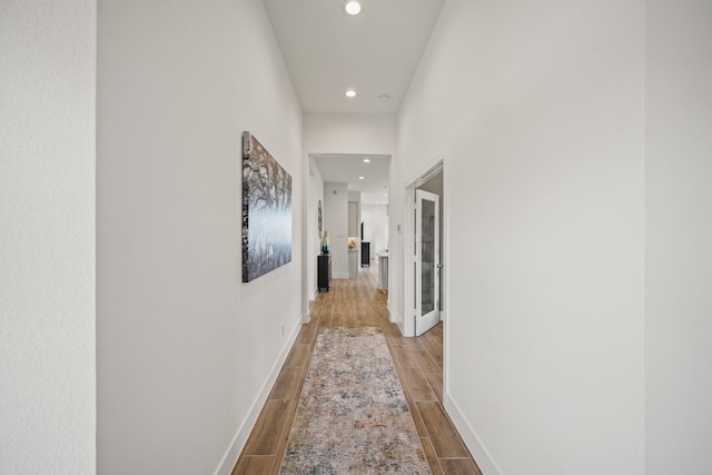 hallway featuring a towering ceiling