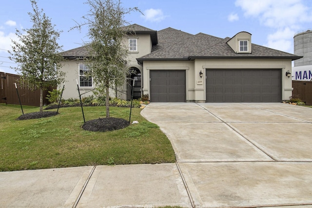 view of front of house with a front yard and a garage