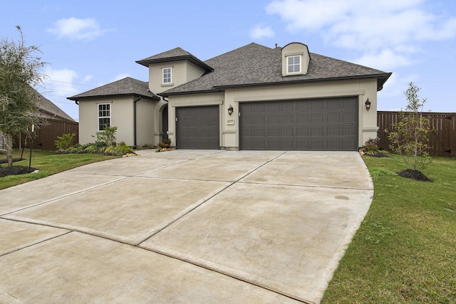 view of front of property featuring a garage and a front lawn