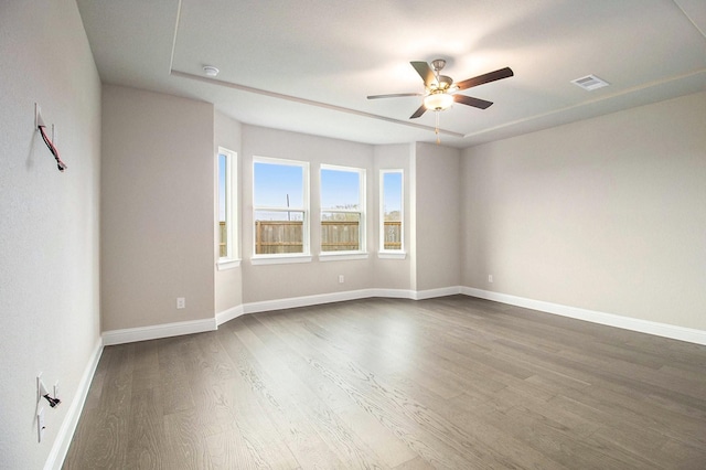 empty room featuring hardwood / wood-style flooring and ceiling fan