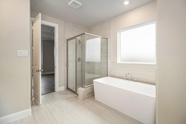 bathroom with separate shower and tub