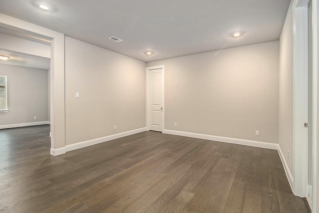 spare room with dark wood-type flooring