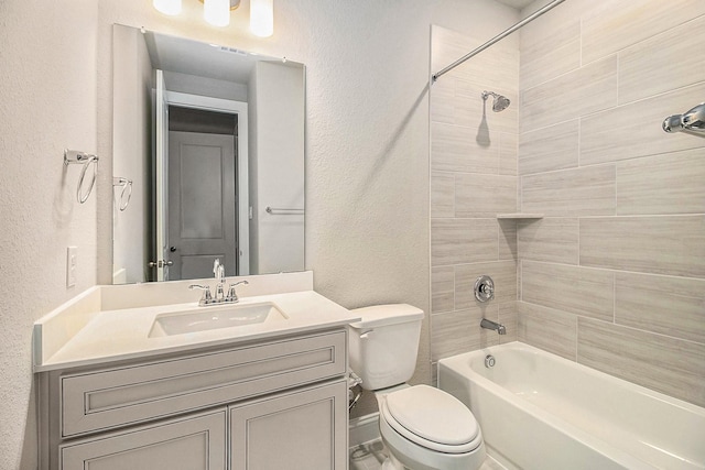 full bathroom with vanity, toilet, and tiled shower / bath