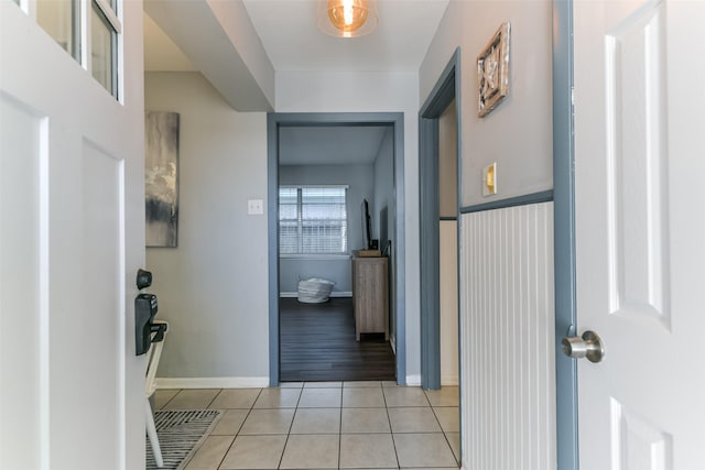 hall featuring light tile patterned floors