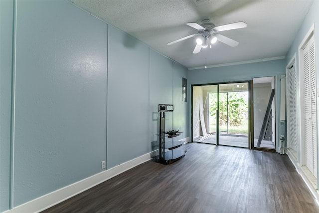 unfurnished room featuring a textured ceiling, ceiling fan, and dark wood-type flooring