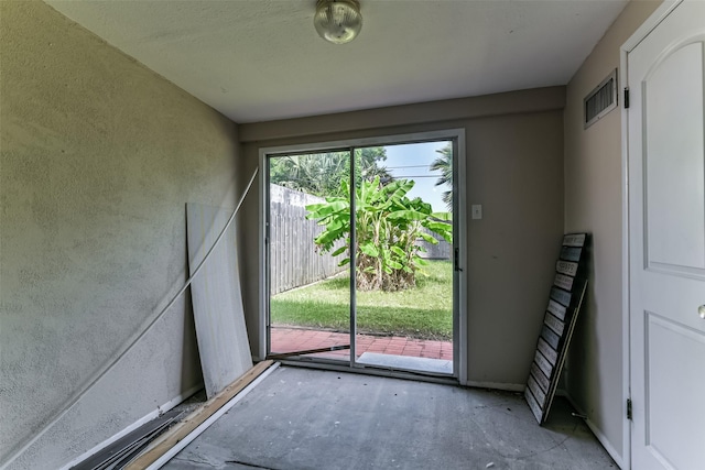 doorway to outside featuring concrete flooring