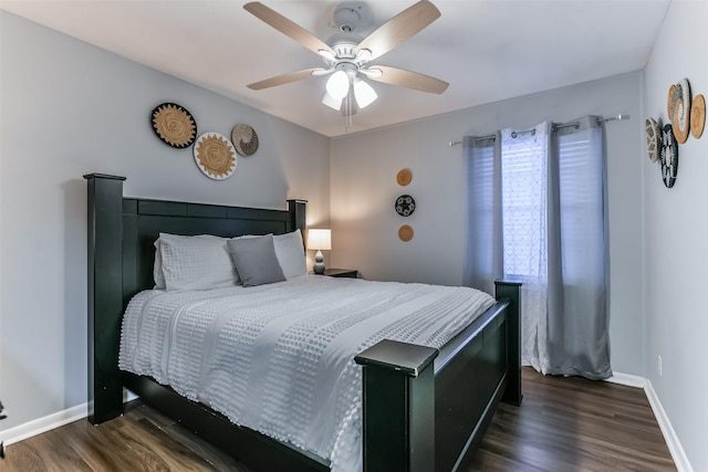 bedroom with ceiling fan and dark hardwood / wood-style flooring