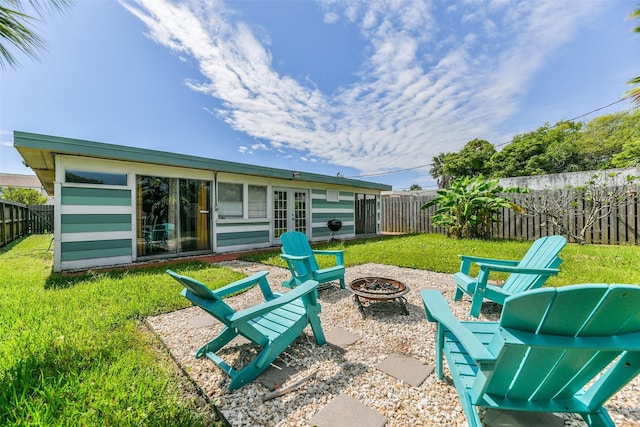 view of patio with french doors and a fire pit