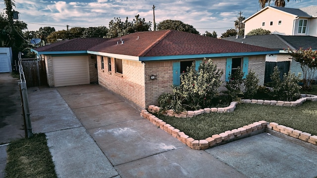 ranch-style home with a garage and a front yard