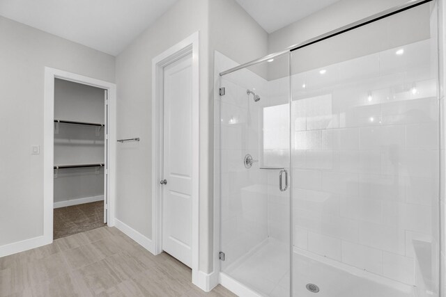 bathroom with a shower with shower door