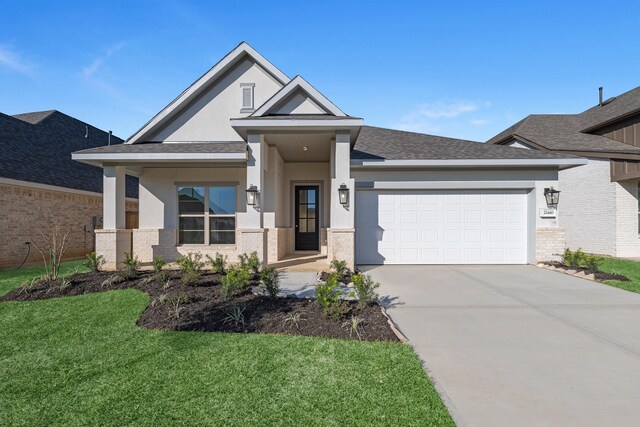 view of front of home featuring a garage and a front yard