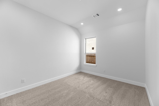 spare room with lofted ceiling and carpet floors