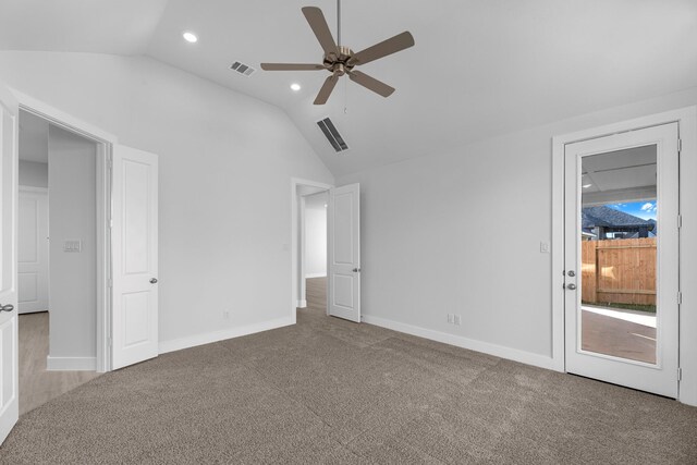 unfurnished bedroom with carpet flooring, ceiling fan, and vaulted ceiling