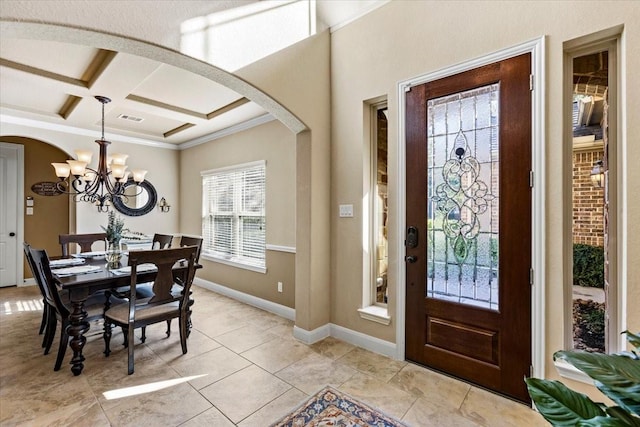 tiled entrance foyer with beam ceiling, crown molding, coffered ceiling, and a notable chandelier