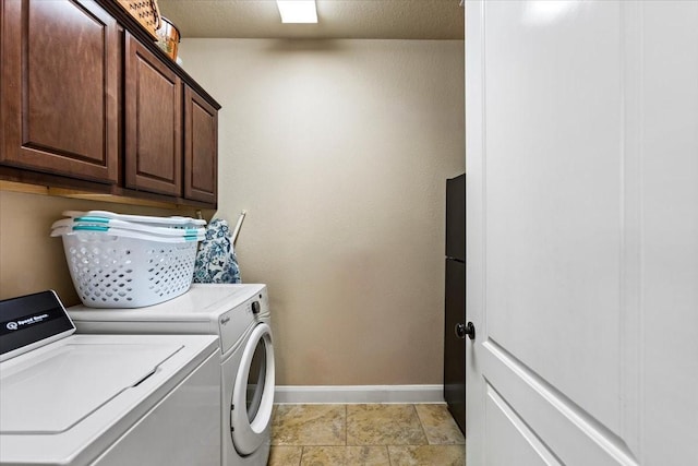 laundry area with washer and dryer and cabinets