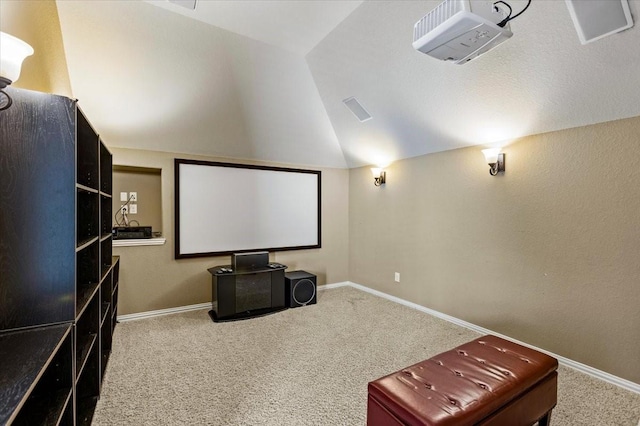 cinema room with carpet and lofted ceiling