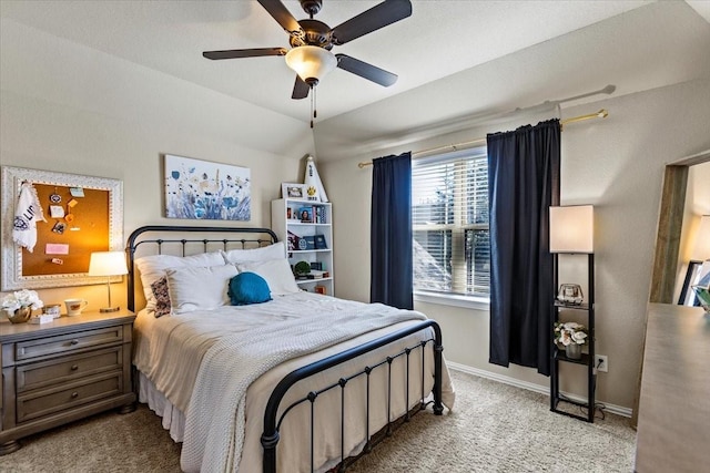 bedroom with ceiling fan, light colored carpet, and vaulted ceiling