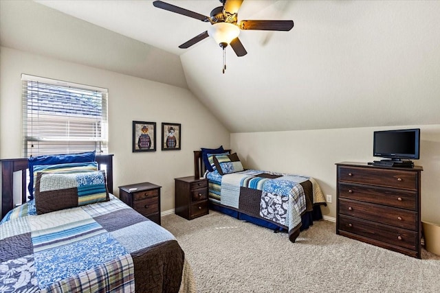 carpeted bedroom featuring ceiling fan and vaulted ceiling