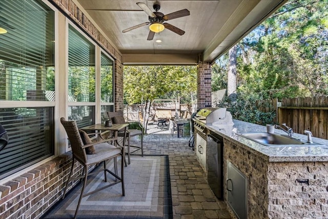 view of patio / terrace featuring grilling area, ceiling fan, sink, and an outdoor kitchen