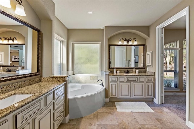 bathroom with a bathing tub and vanity