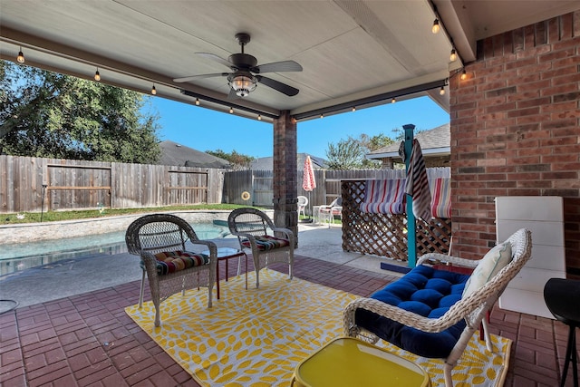 view of patio with a fenced in pool and ceiling fan