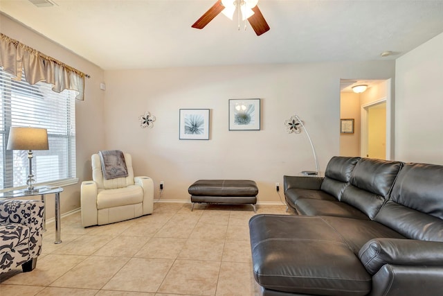 tiled living room featuring plenty of natural light and ceiling fan