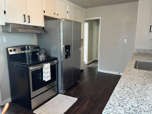 kitchen with white cabinets, light stone counters, electric stove, and dark wood-type flooring